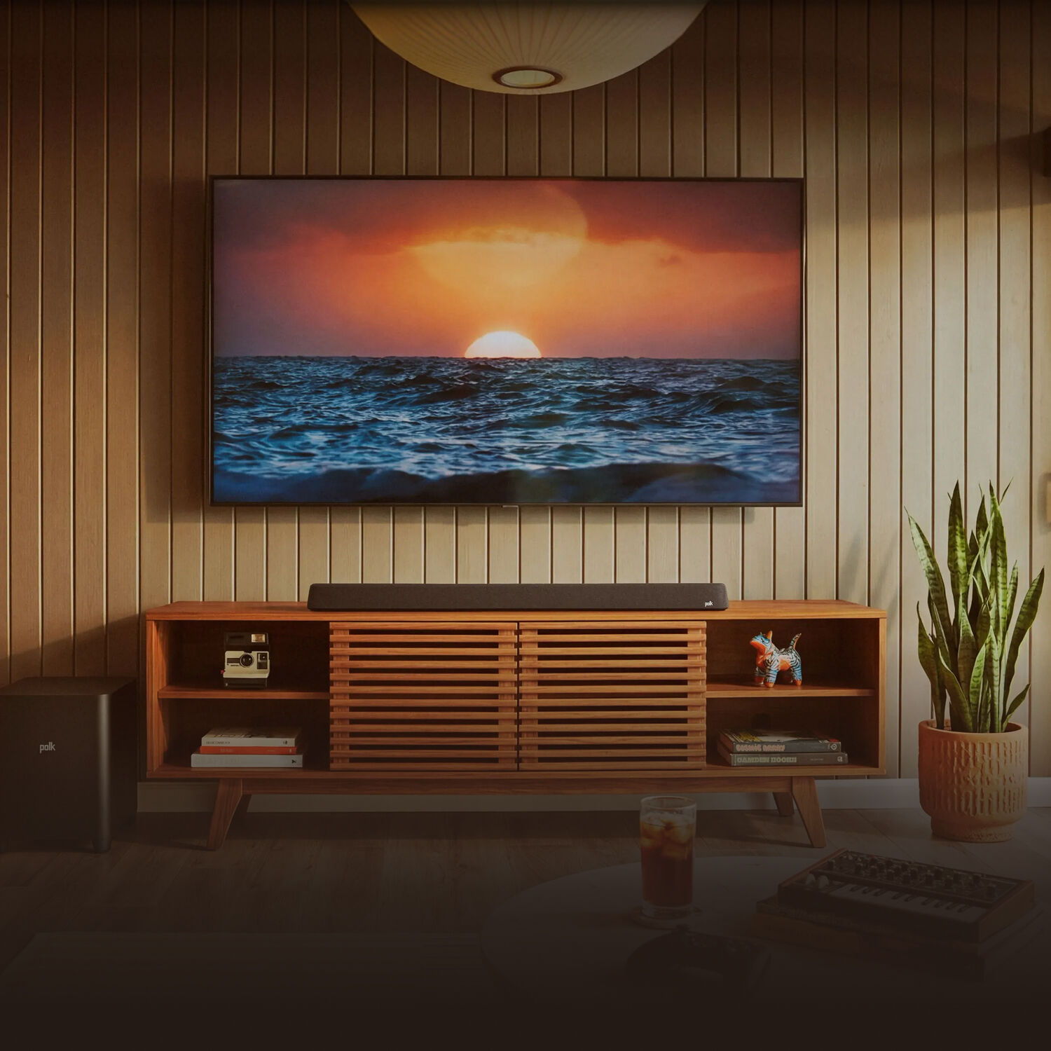 Magnifi Sound Bar on a tv stand with the subwoofer on the floor nearby