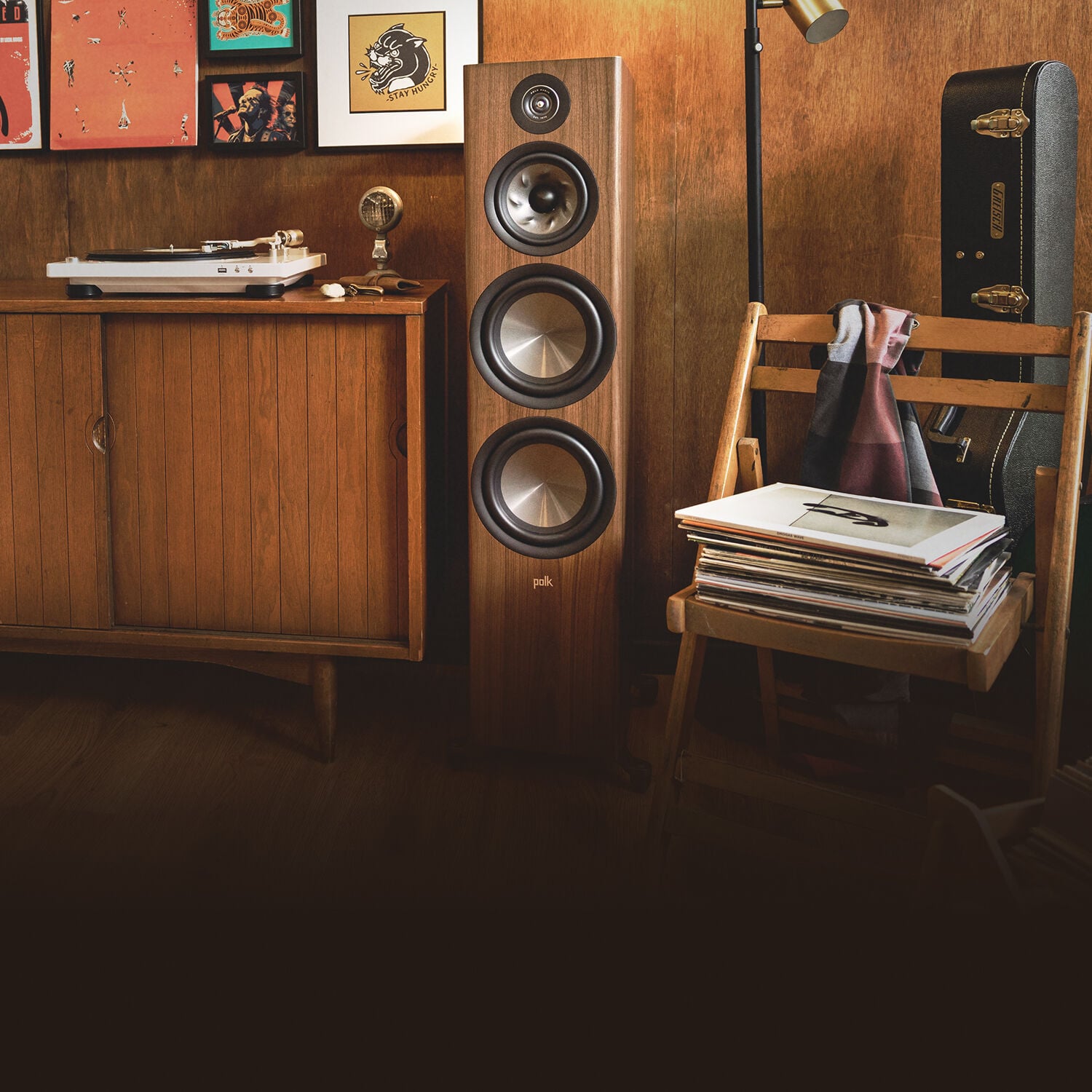 Reserve floor standing speaker in front of a wall of albums