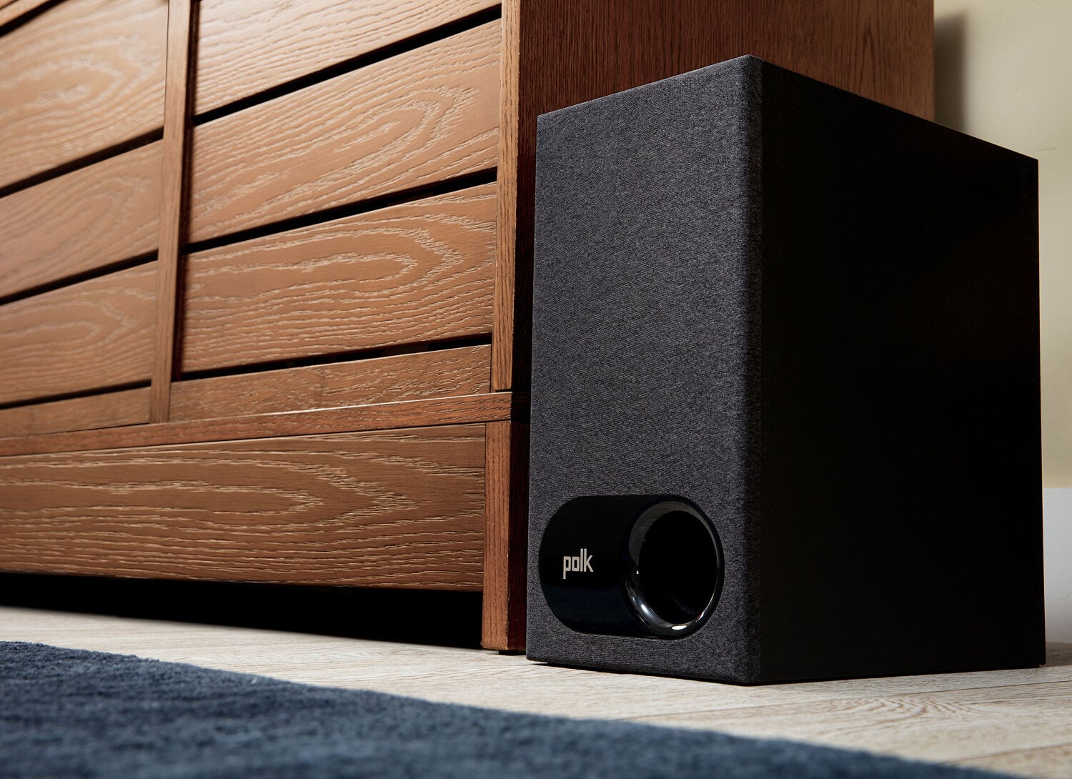 The Signa Subwoofer on the floor by the entertainment center