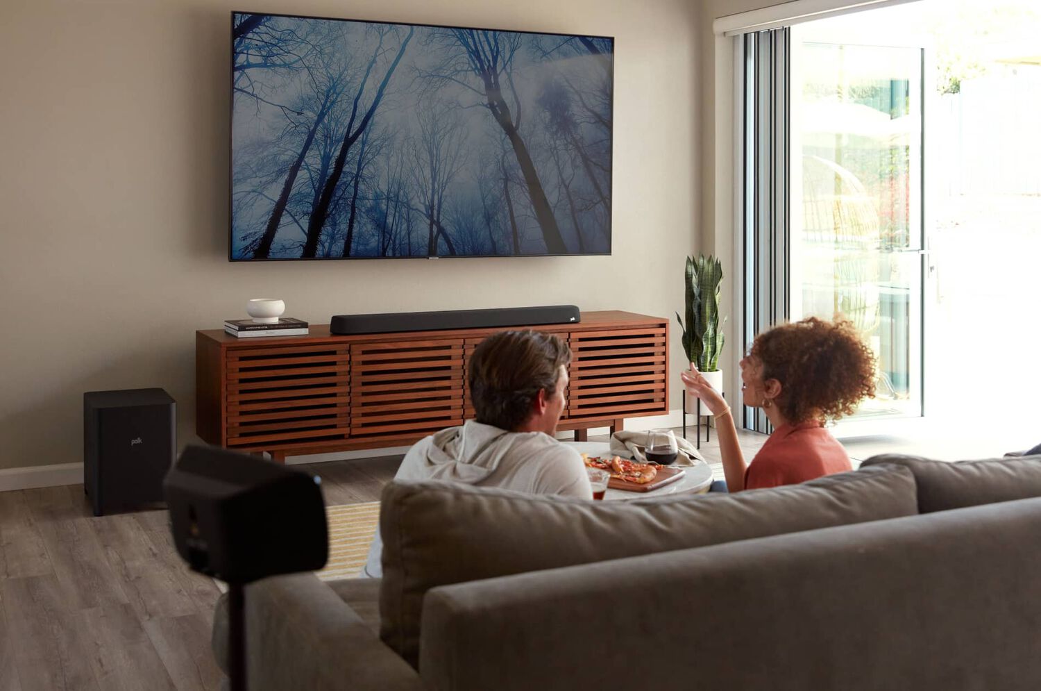 A man and woman watching tv together