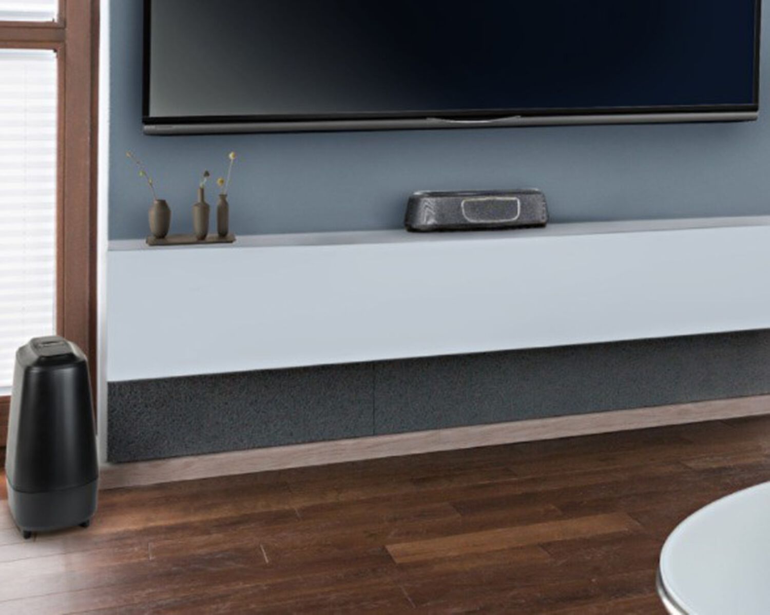 A magnifi sound bar under a tv